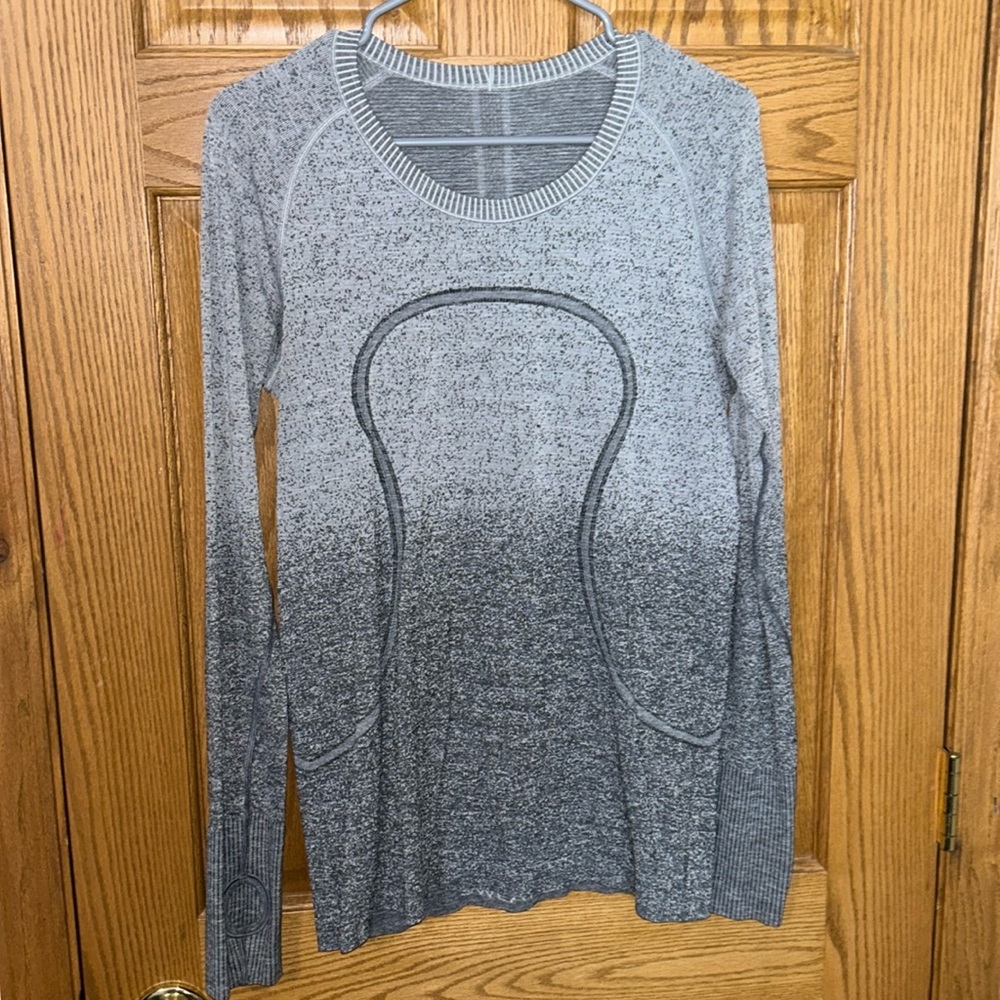 Lululemon grey long sleeve size 10. Two holes on sleeve see picture. No stains.